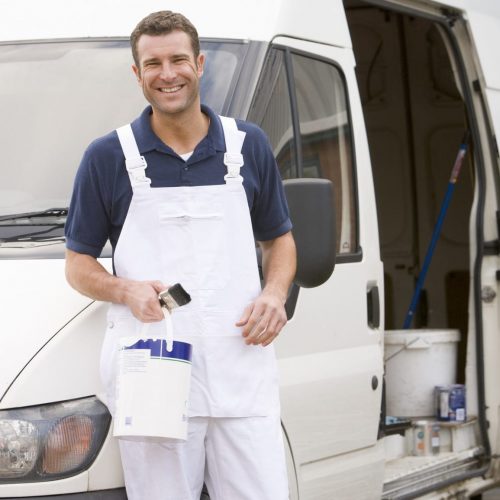 Decorator holding a tin of paint